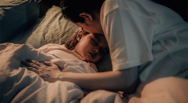 Tucking in your child as they go to sleep can be part of a good bedtime routine for younger children.